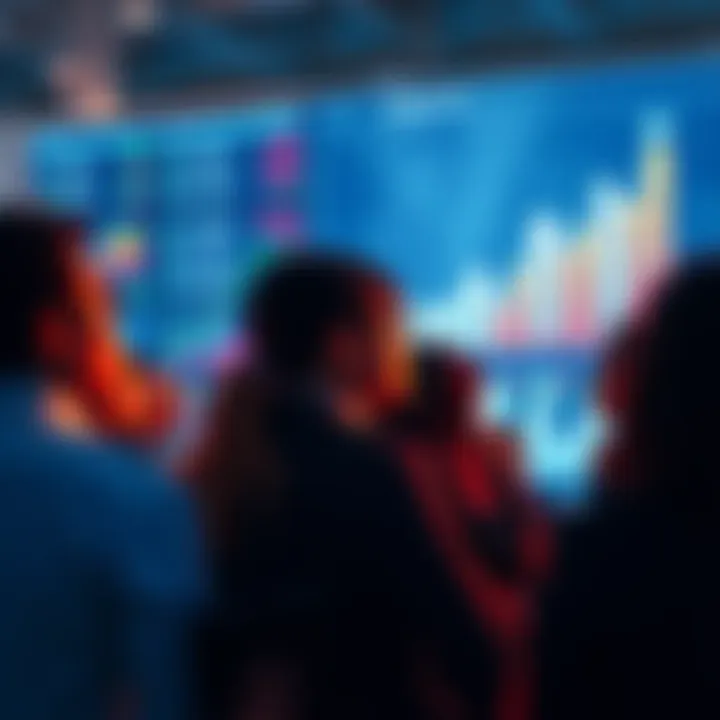 A group of diverse people looking at financial growth charts on a digital screen, symbolizing upcoming investment trends.
