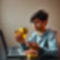 A high school student holding various cryptocurrency coins, contemplating investment options with a laptop nearby.